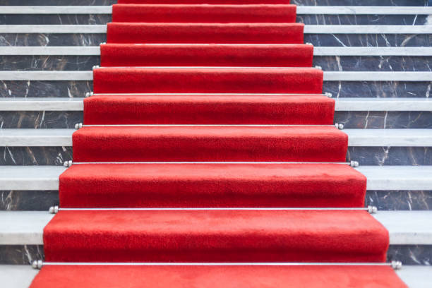 istock Red carpet on the marble staircase 941893860