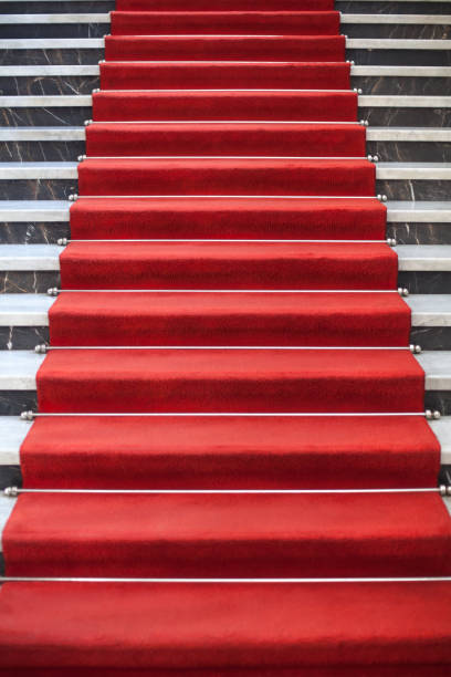 istock Red carpet on the marble staircase 941893910