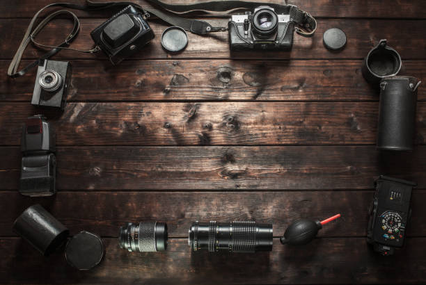 istock Old retro camera on wooden table background 941896326