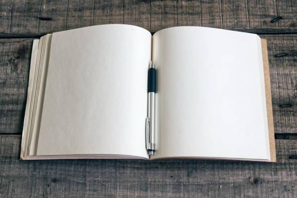 istock Blank page on book and pen on old wood plate 941906000