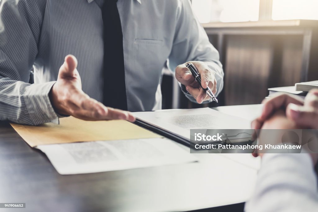 Businessman and Male lawyer or judge consult having team meeting with client, Law and Legal services concept Businessman and Male lawyer or judge consult having team meeting with client, Law and Legal services concept. Advice Stock Photo