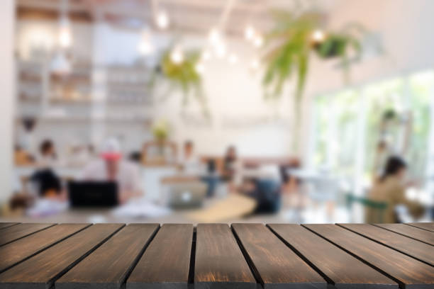 istock Empty wooden table space platform and blurred resturant or coffee shop background for product display montage 941908960