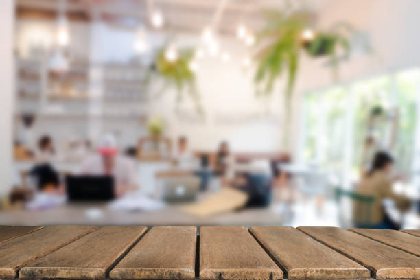 istock Empty wooden table space platform and blurred resturant or coffee shop background for product display montage 941908986