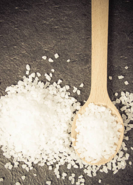 istock Coarse sea salt on dark background. Top view. 941909018