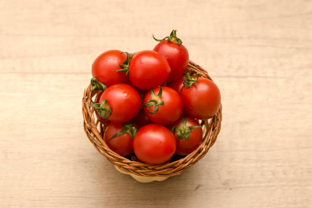 istock cherry tomatoes in a basket on a wooden background 941910258