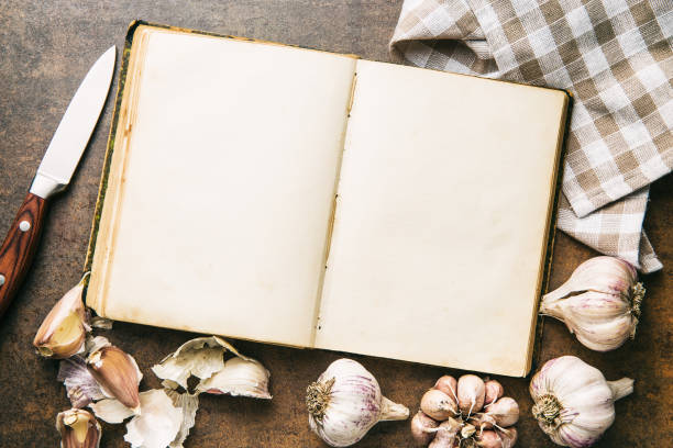 istock Blank cookbook and garlic. Top view. 941919196