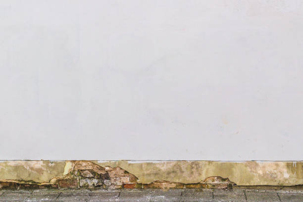 istock Aged abandoned street wall with pavement ground background 941931608