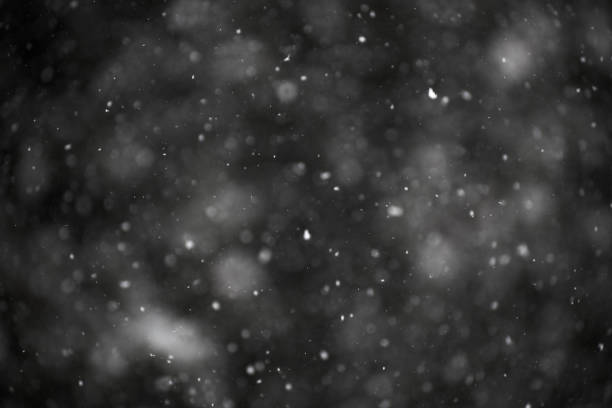 istock photo of natural snow falling on a dark background, good to use as a template for composing images in overlay or screen layer mode, winter theme 941932004
