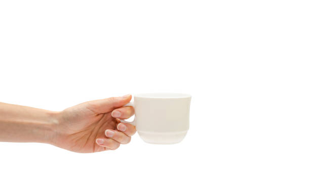 istock woman hand holding white cup. Isolated on white background. copy space, template. 941936216