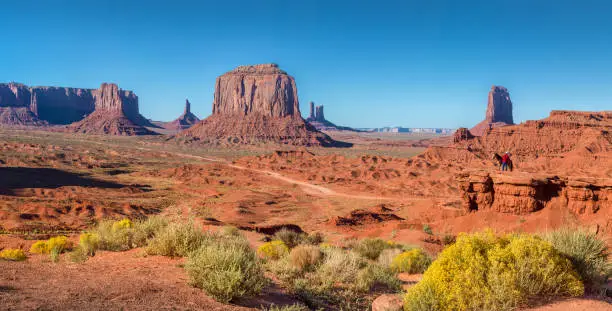 Photo of Monument Valley panorama with horse rider at sunset, Arizona, USA