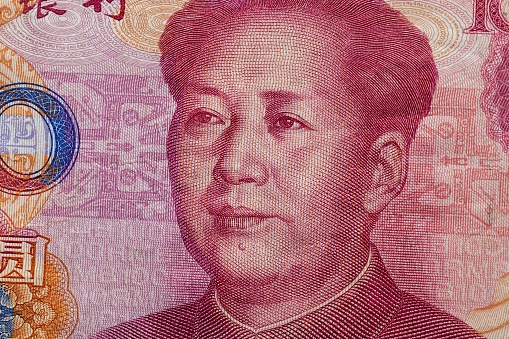 Close up of one hundred Yuan banknote with focus on portrait of Chinese statesman Mao Tse-tung