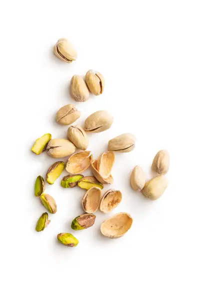 Peeled pistachio nuts isolated on white background. Top view.