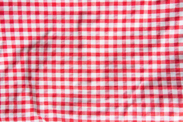 The crumpled checkered tablecloth background. Top view.