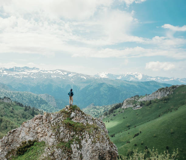 istock Hiker standing on peak of rock. 941946856