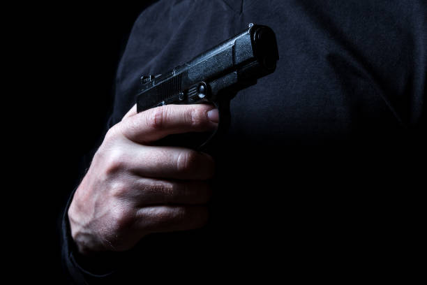 istock gun in the hand of man 941947476