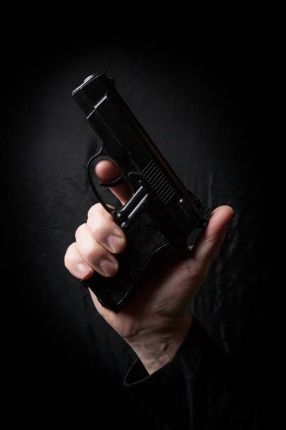 istock gun in the hand of man 941947482