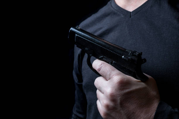istock gun in the hand of man 941947486