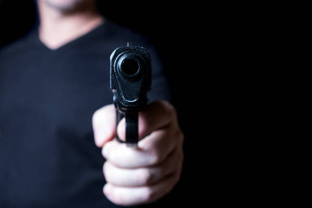 istock gun in the hand of man 941947672