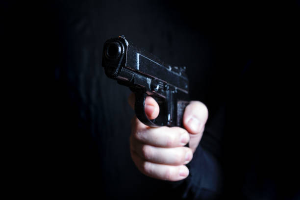 istock gun in the hand of man 941949100