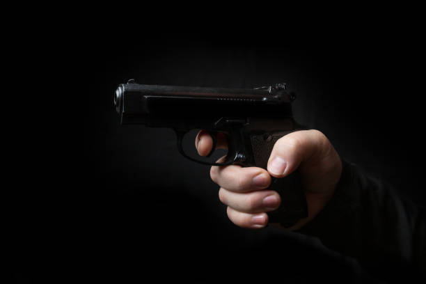 istock gun in the hand of man 941949118