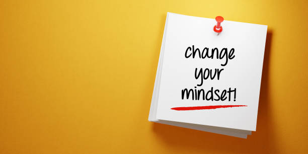 istock White Sticky Note with Change Your Mindset Message And Red Push Pin On Yellow Background 941949732