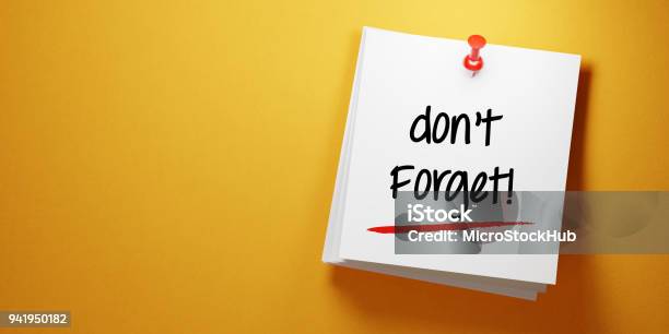 White Sticky Note With Dont Forget Message And Red Push Pin On Yellow Background Stock Photo - Download Image Now