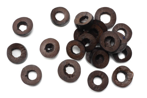 istock Marinated slices black olives isolated on white background. top view 941950206