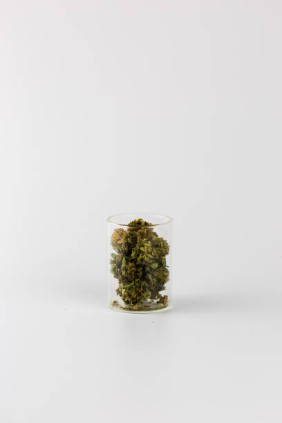 istock Marijuana in clear glass jar isolated on white 941950744
