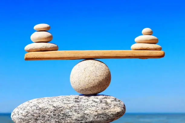 Photo of Concept of harmony and balance. Balance stones against the sea.