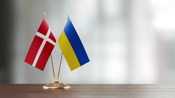 istock Danish And Ukrainian Flag Pair On A Desk Over Defocused Background 941953906