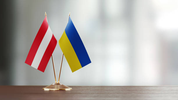 istock Austrian And Ukrainian Flag Pair On A Desk Over Defocused Background 941954688