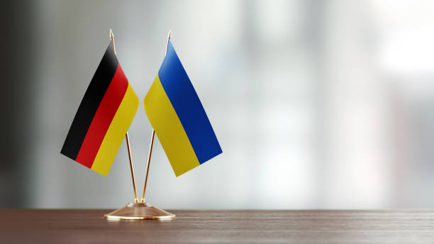 istock German And Ukrainian Flag Pair On A Desk Over Defocused Background 941954960