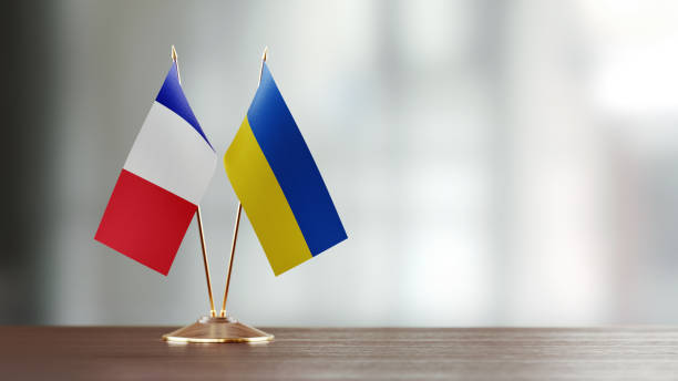 istock French And Ukrainian Flag Pair On A Desk Over Defocused Background 941955038