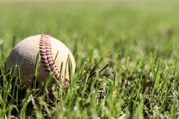 istock Baseball season is here.  Weathered ball on field. 941969216