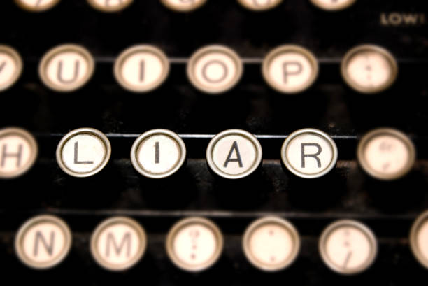 istock Keys on a antique typewriter close-up word LIAR 941969272