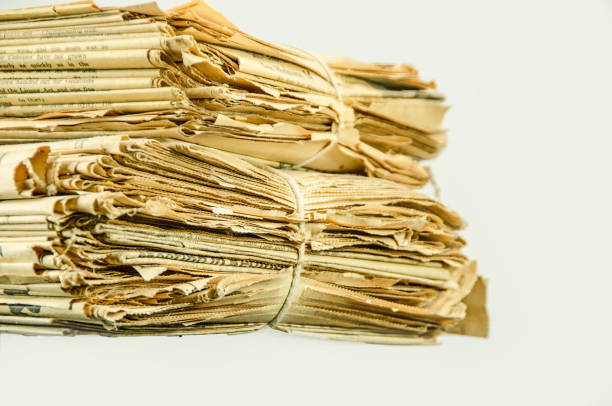 istock Stack of very old yellowed newspapers tied together 941969376