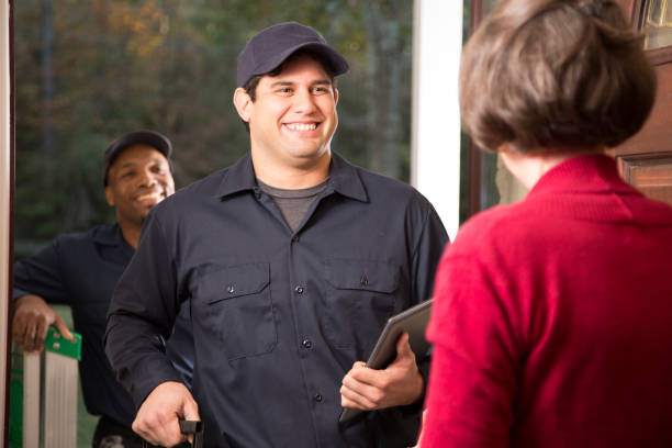 istock Repairmen arrive at customer's front door for home repairs. 941969624