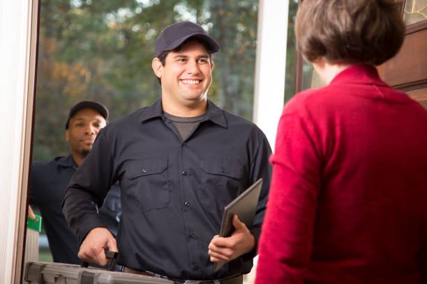 istock Repairmen arrive at customer's front door for home repairs. 941969682