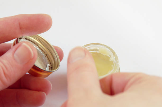 istock Hands using rich Oil or Chrism from a Crucible, on white background 941988132