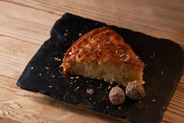 Photo of Delicious slice of freshly baked apple pie on shale board