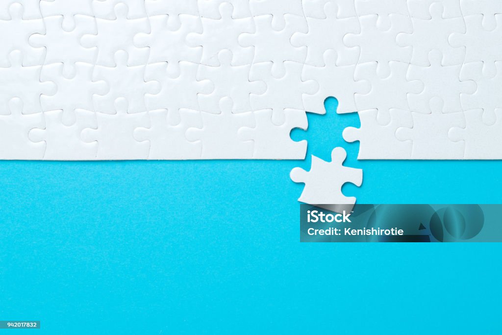 Blue background made from jigsaw puzzle Blue background made from white puzzle pieces and place for your content Puzzle Stock Photo