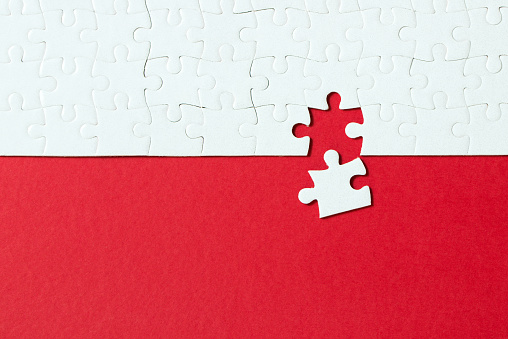 Red background made from white puzzle pieces and place for your content