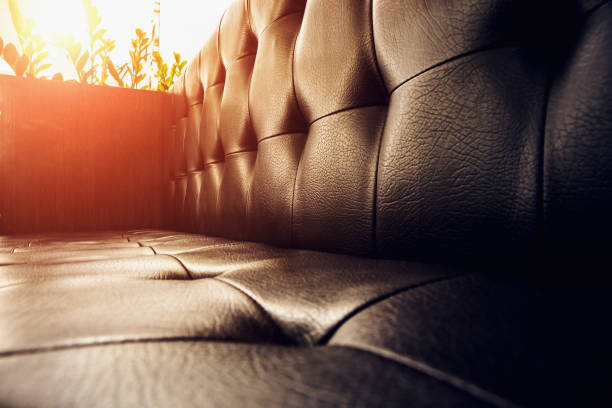 vintage brown leather sofa at sunset light - armchair sofa leather brown imagens e fotografias de stock