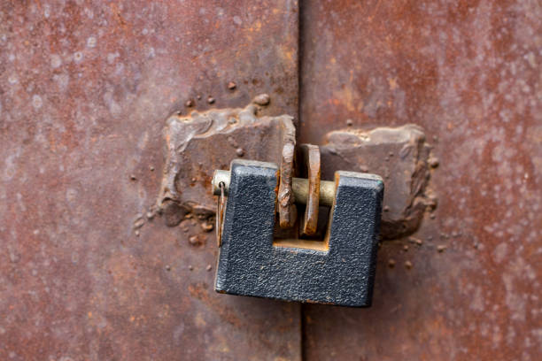 istock Old locked iron gate with Steel padlock, Close up 942024582