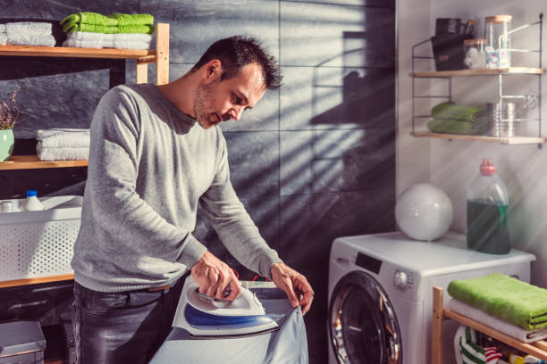istock Men ironing clothes at home 942029136