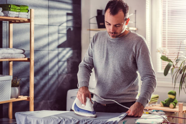 istock Men ironing clothes at home 942029450