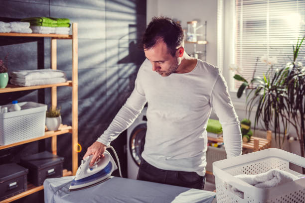 istock Men ironing clothes at home 942029664