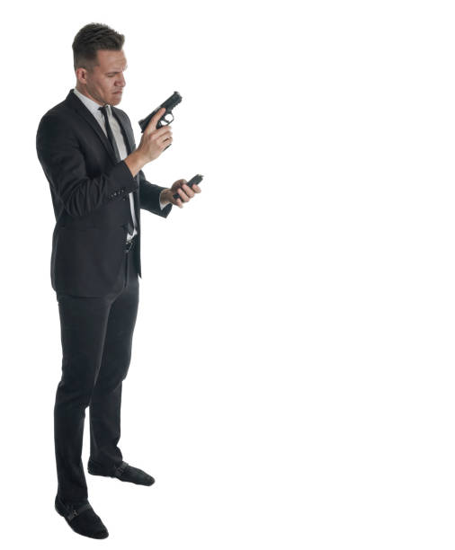 istock Businessman holding handgun and phone 942029752