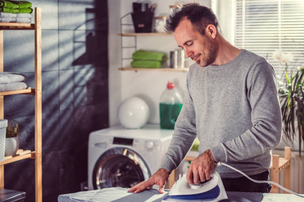 istock Men ironing clothes at home 942029864
