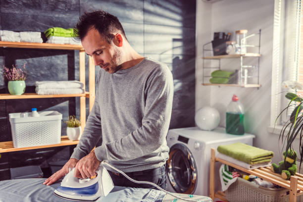 istock Men ironing clothes at home 942030002